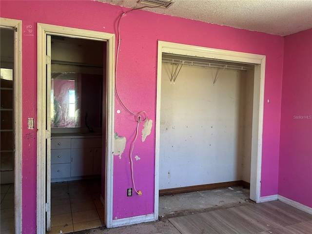 2250 Maple Hill Dr, Lakeland, FL 33811 - unfurnished bedroom with a closet and a textured ceiling