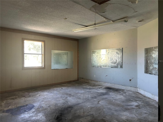 2250 Maple Hill Dr, Lakeland, FL 33811 - spare room featuring concrete flooring and wood walls