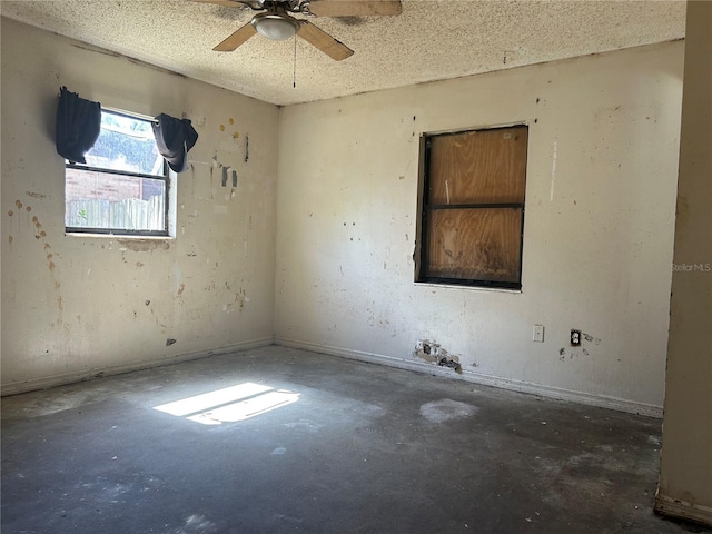 2250 Maple Hill Dr, Lakeland, FL 33811 - unfurnished room featuring unfinished concrete floors, ceiling fan, and a textured ceiling