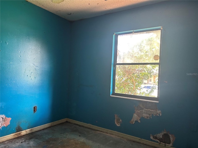 2250 Maple Hill Dr, Lakeland, FL 33811 - empty room featuring concrete floors and a textured ceiling