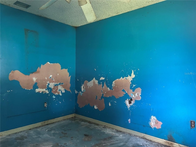 2250 Maple Hill Dr, Lakeland, FL 33811 - unfurnished room featuring unfinished concrete floors, a textured ceiling, and a ceiling fan