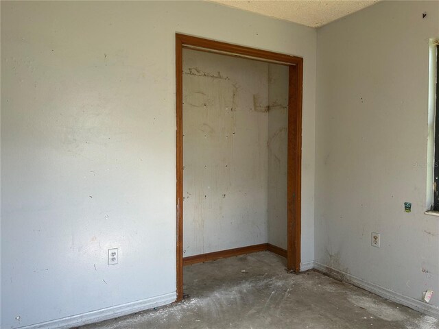 2250 Maple Hill Dr, Lakeland, FL 33811 - unfurnished bedroom with concrete floors and a closet