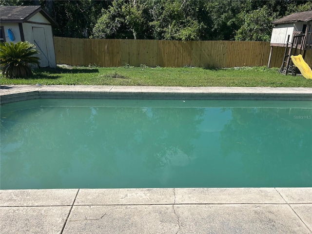 2250 Maple Hill Dr, Lakeland, FL 33811 - view of pool featuring a storage shed and a fenced backyard