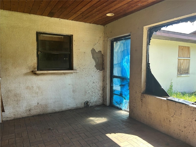 2250 Maple Hill Dr, Lakeland, FL 33811 - spare room with brick patterned flooring and wood ceiling