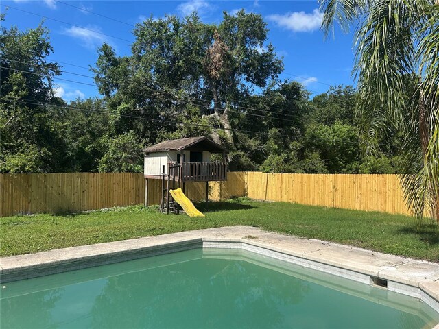 2250 Maple Hill Dr, Lakeland, FL 33811 - view of pool featuring a playground and a fenced backyard