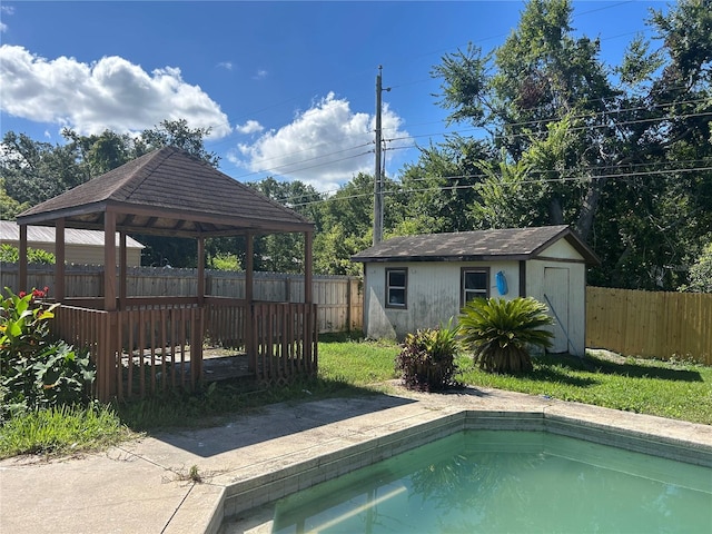 2250 Maple Hill Dr, Lakeland, FL 33811 - view of swimming pool with a gazebo, a fenced backyard, and a storage unit