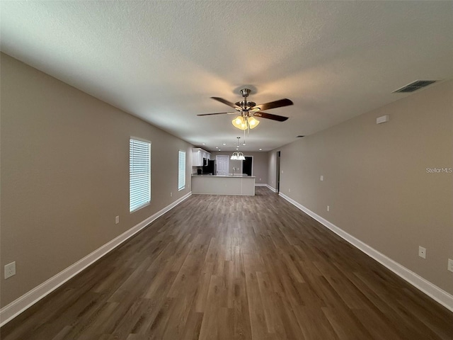 4042 Old Bartow Eagle Lake Rd, Bartow, FL 33830 - unfurnished living room with ceiling fan, dark wood-style floors, and a textured ceiling