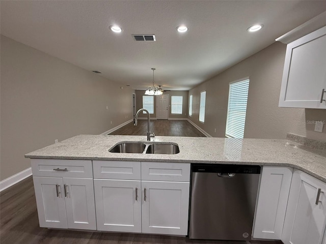 4042 Old Bartow Eagle Lake Rd, Bartow, FL 33830 - kitchen with stainless steel dishwasher, white cabinetry, dark wood-type flooring, light stone counters, and a peninsula