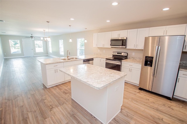 4042 Old Bartow Eagle Lake Rd, Bartow, FL 33830 - kitchen featuring stainless steel appliances, a peninsula, recessed lighting, light wood-style floors, and a center island
