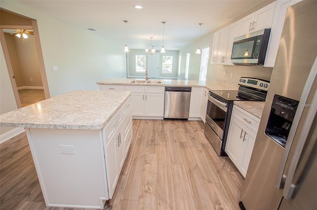 4042 Old Bartow Eagle Lake Rd, Bartow, FL 33830 - kitchen featuring appliances with stainless steel finishes, a peninsula, light wood-style flooring, white cabinets, and recessed lighting