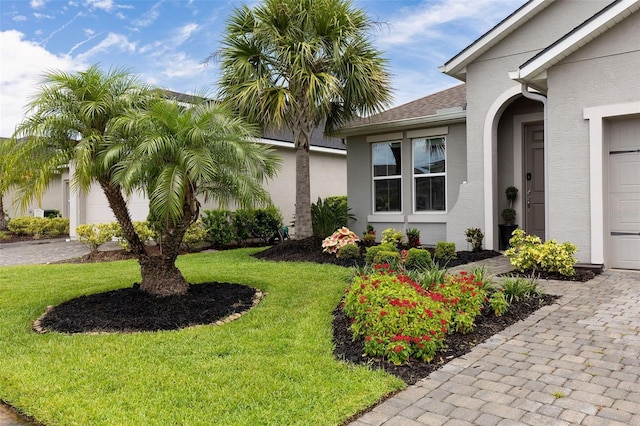 180 Azure Mist Way, Daytona Beach, FL 32124 - entrance to property featuring stucco siding, a yard, and driveway