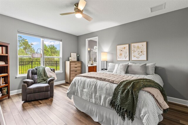 180 Azure Mist Way, Daytona Beach, FL 32124 - bedroom with wood finished floors, connected bathroom, and a ceiling fan