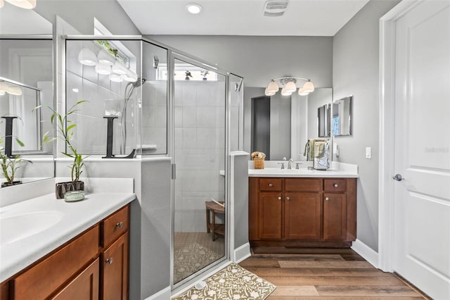 180 Azure Mist Way, Daytona Beach, FL 32124 - full bathroom with a stall shower, two vanities, wood finished floors, and recessed lighting
