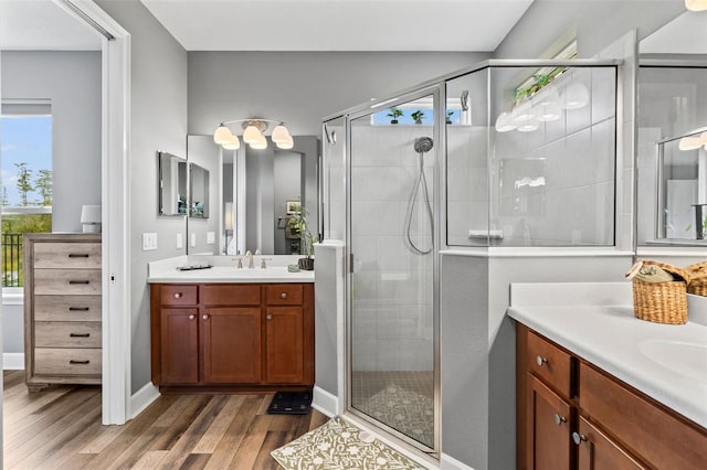 180 Azure Mist Way, Daytona Beach, FL 32124 - bathroom featuring wood finished floors, two vanities, and a stall shower