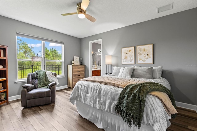 180 Azure Mist Way, Daytona Beach, FL 32124 - bedroom with wood finished floors, ensuite bathroom, and ceiling fan