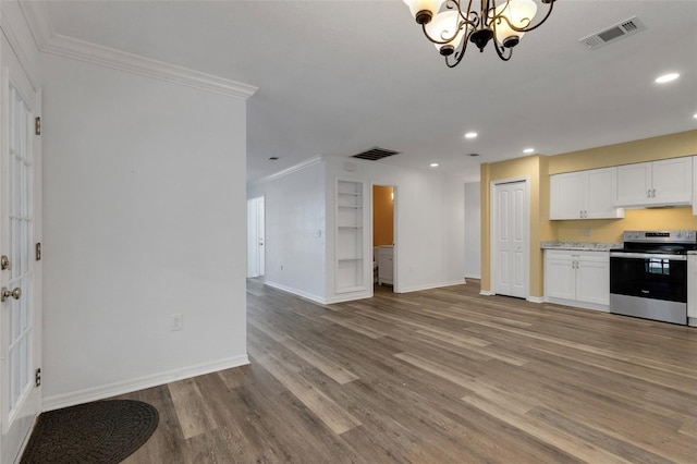 5722 Antler Trl, Lakeland, FL 33811 - kitchen with electric range, recessed lighting, a chandelier, ornamental molding, and wood finished floors