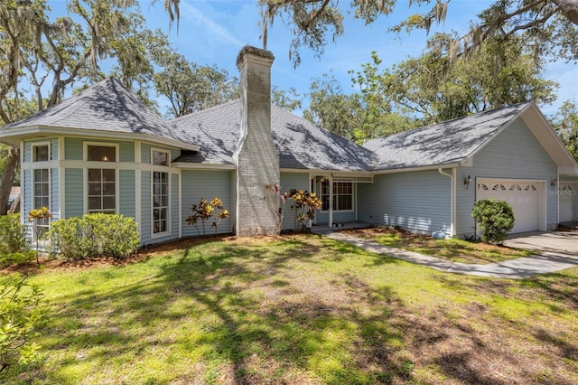 5722 Antler Trl, Lakeland, FL 33811 - view of front of house featuring an attached garage, a chimney, a front yard, driveway, and roof with shingles