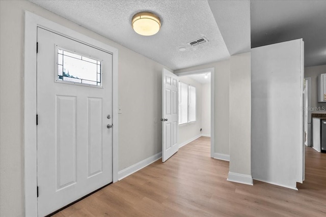 405 S 7th Ave, Bartow, FL 33830 - foyer entrance featuring wood finished floors, healthy amount of natural light, and a textured ceiling