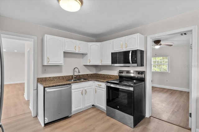 405 S 7th Ave, Bartow, FL 33830 - kitchen with stainless steel appliances, white cabinetry, light wood-style floors, and a ceiling fan