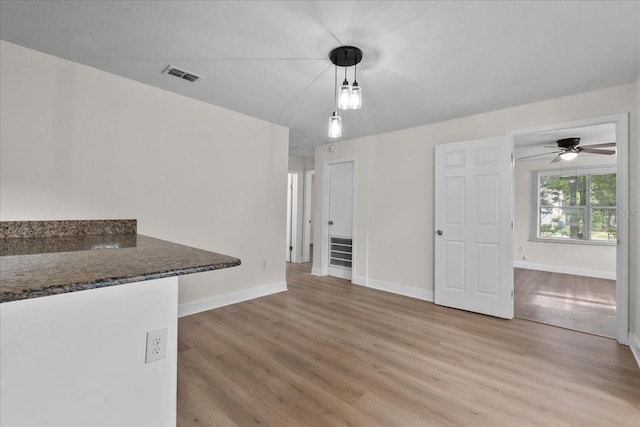 405 S 7th Ave, Bartow, FL 33830 - unfurnished living room featuring light wood-style flooring and a ceiling fan