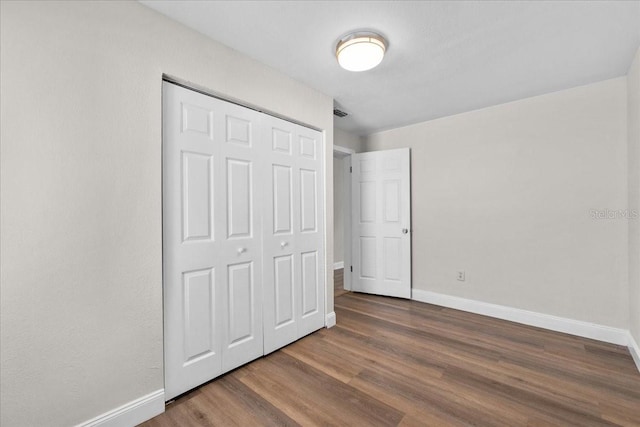 405 S 7th Ave, Bartow, FL 33830 - unfurnished bedroom with wood finished floors and a closet