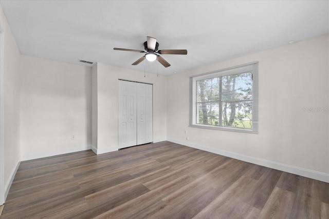 405 S 7th Ave, Bartow, FL 33830 - unfurnished bedroom with wood finished floors, a closet, and a ceiling fan