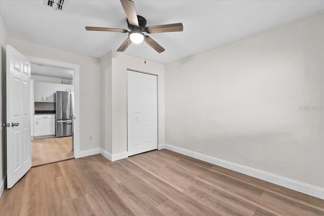 405 S 7th Ave, Bartow, FL 33830 - unfurnished bedroom with freestanding refrigerator, light wood-type flooring, ceiling fan, and a closet