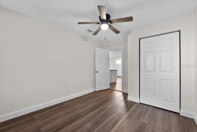 405 S 7th Ave, Bartow, FL 33830 - unfurnished bedroom with dark wood finished floors, a closet, and a ceiling fan