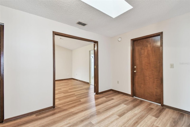 849 Rockingham Rd, Lakeland, FL 33809 - empty room featuring light wood-type flooring and a skylight