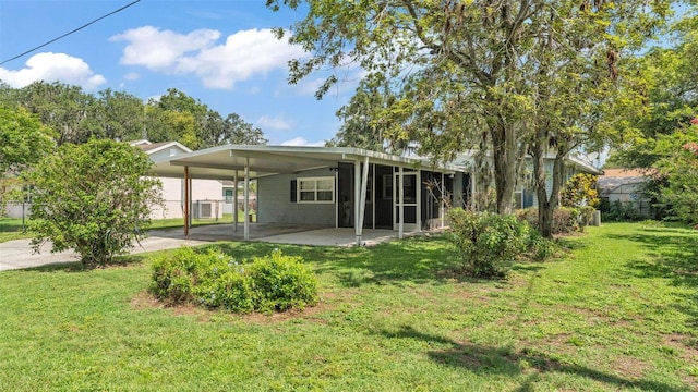640 Forrest Dr, Bartow, FL 33830 - rear view of house with a lawn and an attached carport