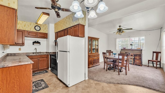 640 Forrest Dr, Bartow, FL 33830 - kitchen featuring freestanding refrigerator, ceiling fan, stainless steel electric stove, brown cabinetry, and light colored carpet