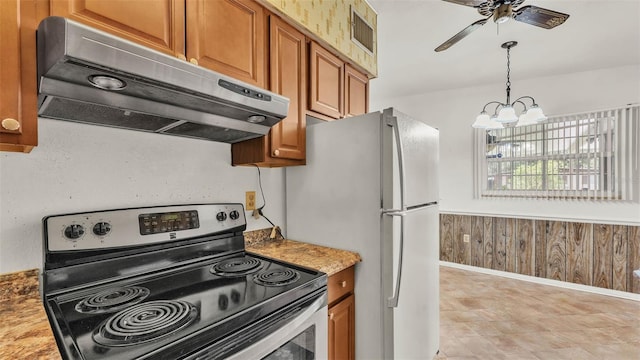 640 Forrest Dr, Bartow, FL 33830 - kitchen featuring stainless steel range with electric cooktop, range hood, brown cabinetry, ceiling fan, and wood walls