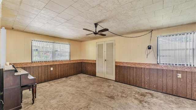 640 Forrest Dr, Bartow, FL 33830 - carpeted empty room with ceiling fan, wood walls, and a wainscoted wall