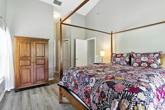 6410 Beechnut Dr, Lakeland, FL 33813 - bedroom with high vaulted ceiling, light wood-type flooring, and a closet