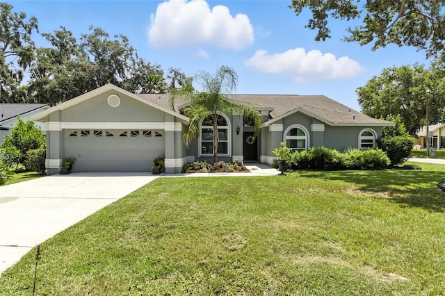 6410 Beechnut Dr, Lakeland, FL 33813 - ranch-style home featuring a garage, stucco siding, concrete driveway, and a front yard