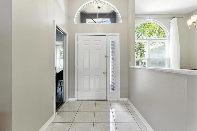 6410 Beechnut Dr, Lakeland, FL 33813 - foyer featuring light tile patterned floors and a chandelier