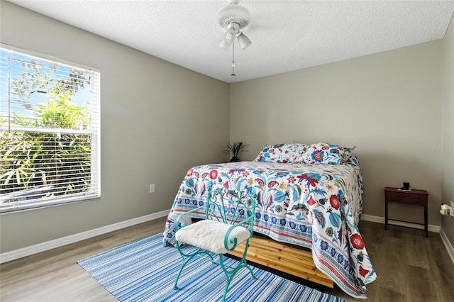 6410 Beechnut Dr, Lakeland, FL 33813 - bedroom with wood finished floors, a textured ceiling, and a ceiling fan
