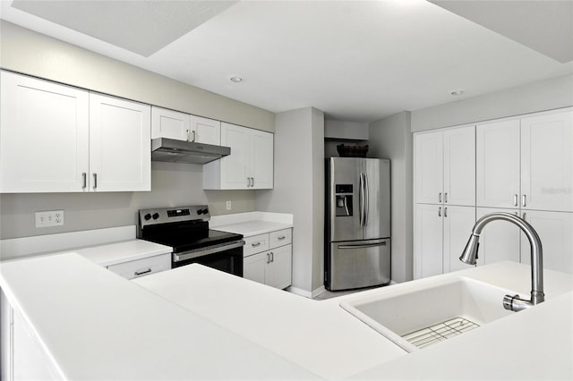 6410 Beechnut Dr, Lakeland, FL 33813 - kitchen with stainless steel appliances, under cabinet range hood, white cabinetry, light countertops, and recessed lighting