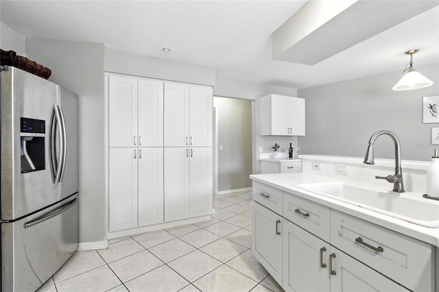6410 Beechnut Dr, Lakeland, FL 33813 - kitchen featuring stainless steel refrigerator with ice dispenser, white cabinetry, light countertops, pendant lighting, and light tile patterned floors