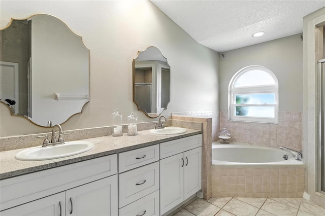 6410 Beechnut Dr, Lakeland, FL 33813 - bathroom featuring a garden tub, double vanity, a textured ceiling, and an enclosed shower