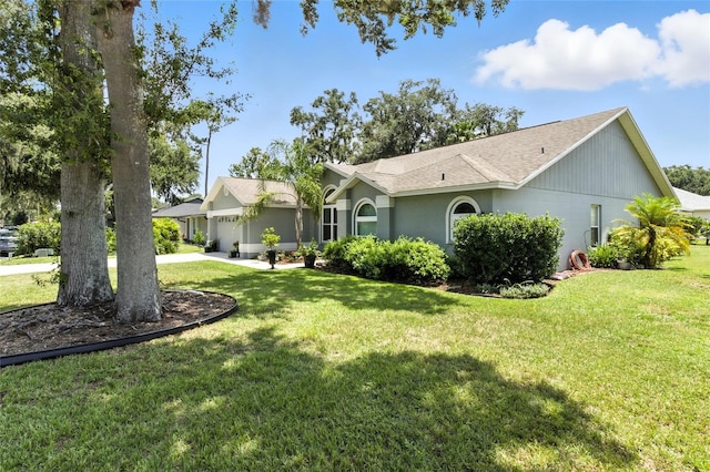 6410 Beechnut Dr, Lakeland, FL 33813 - view of front of house featuring a front yard, an attached garage, concrete driveway, and a shingled roof