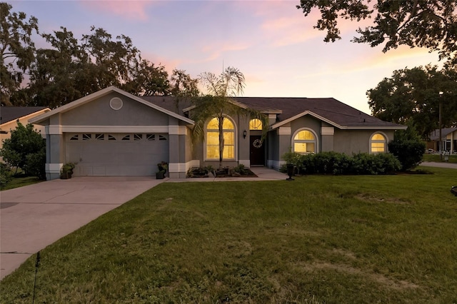 6410 Beechnut Dr, Lakeland, FL 33813 - single story home featuring a garage, driveway, stucco siding, and a front yard