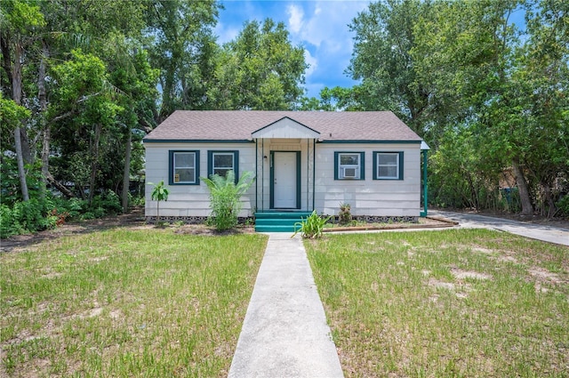 1133 Bryn Mawr Ave, Lake Wales, FL 33853 - bungalow-style house with a front yard and roof with shingles