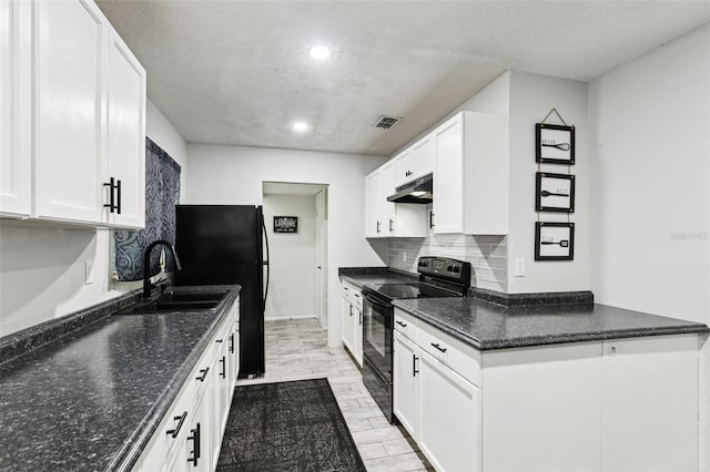 3854 Feather Dr, Lakeland, FL 33812 - kitchen with black appliances, under cabinet range hood, tasteful backsplash, white cabinets, and recessed lighting