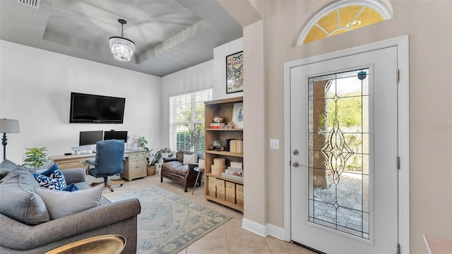 11825 Frost Aster Dr, Riverview, FL 33579 - living area with light tile patterned floors, a desk, a chandelier, a tray ceiling, and arched walkways