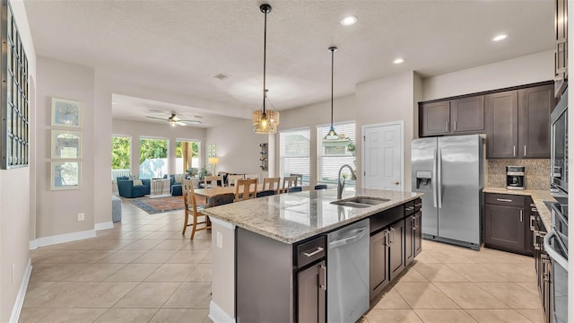 11825 Frost Aster Dr, Riverview, FL 33579 - kitchen with stainless steel appliances, ceiling fan, light tile patterned flooring, dark brown cabinets, and recessed lighting