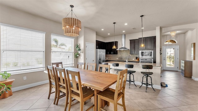 11825 Frost Aster Dr, Riverview, FL 33579 - dining room with arched walkways, light tile patterned floors, plenty of natural light, and recessed lighting