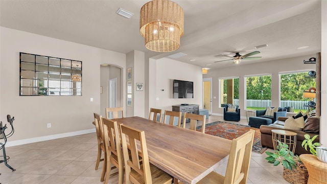 11825 Frost Aster Dr, Riverview, FL 33579 - dining area with light tile patterned floors, arched walkways, ceiling fan, and a chandelier