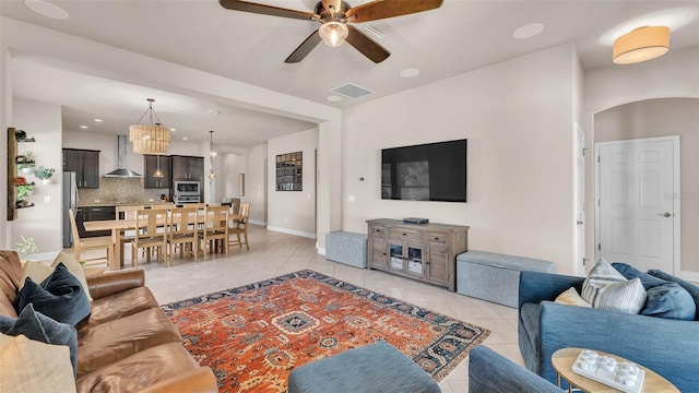 11825 Frost Aster Dr, Riverview, FL 33579 - living room with light tile patterned flooring, ceiling fan, arched walkways, and a chandelier