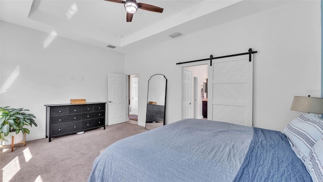 11825 Frost Aster Dr, Riverview, FL 33579 - bedroom featuring a barn door, carpet flooring, ceiling fan, a raised ceiling, and ensuite bath